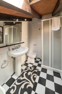 a bathroom with a sink and a toilet and a shower at INVICUTUS in Brescia