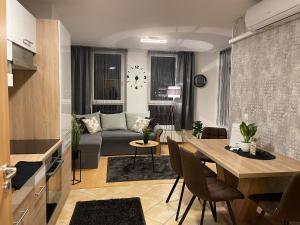 a living room with a couch and a table at Európa 20 Apartman in Bük