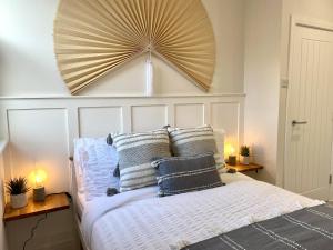 a bedroom with a bed with a large headboard at Stunning Beach Themed 2 Bed Apartment in Bournemouth