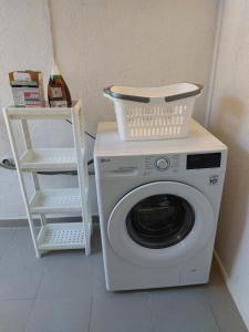a washing machine with a basket on top of it at Eisenstadt Apartments in Eisenstadt