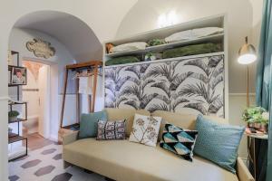 un soggiorno con divano e cuscini sopra di Busdraghi Studio, a stylish studio along Via Fillungo a Lucca