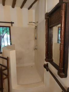 a stairway with a mirror and a mirror at Gulu House in Malindi