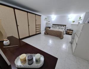 a bedroom with a bed and a table in a room at Capogallo47 in Mondello