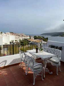a table and chairs on a balcony with a view at Attic in Cadaques in Cadaqués