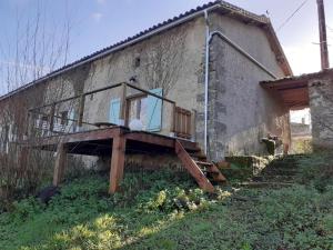 a house with a porch on the side of it at Au coeur de la nature avec toilettes sèches in Saint-Martin-du-Fouilloux