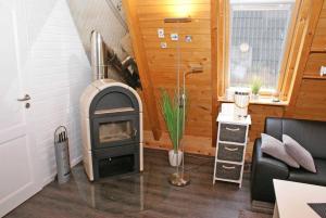 a living room with a wood stove in a room at wenige Meter bis zum Strand in Damp