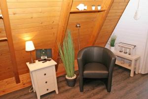 a room with a chair and a desk with a lamp at wenige Meter bis zum Strand in Damp