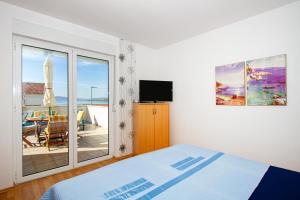 a bedroom with a bed and a sliding glass door at Villa Bianca in Trogir