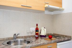 a kitchen sink with wine bottles and wine glasses at Villa Bianca in Trogir +128 photos