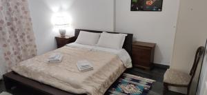 a bedroom with a bed with two towels on it at La Badia del Cavaliere 1 in Rome