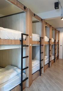 a group of bunk beds in a room at Little One in Chiang Rai