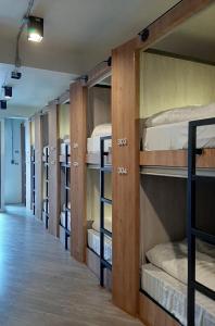 a row of bunk beds in a room at Little One in Chiang Rai