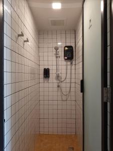 a shower stall in a bathroom with white tiles at Little One in Chiang Rai +53 photos