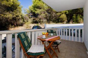 a patio with a table and chairs on a balcony at Villa Bianca in Trogir