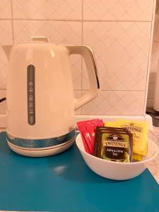 a tea kettle and a bowl of spices on a counter at Casa Manolo Cesano Suite Apartment Milan in Cesano Boscone