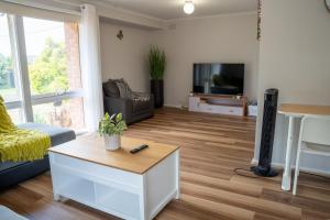 uma sala de estar com um sofá e uma televisão em Cosy 4 Bedroom Holiday Home - Melbourne Airport em Greenvale