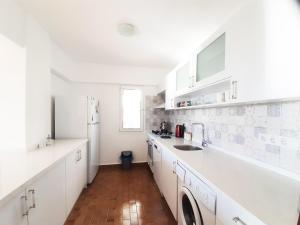 a kitchen with white cabinets and a sink at Ertem Apart in Datca