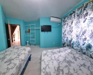 En eller flere senge i et værelse på Casa Hostel San Andres