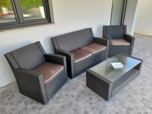 three wicker chairs and a coffee table in a room at Hall 92 Quartos com WC em moradia com piscina A-das-Lebres Loures in Loures