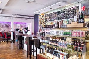 a bar with a lot of bottles of alcohol at Best Western Motala Stadshotell in Motala