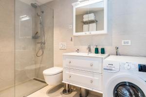 a bathroom with a washing machine and a sink at Luxury apartments Azalea Primošten in Primošten