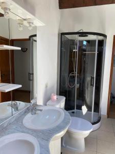 a bathroom with two sinks and a toilet and a shower at Le Cévenn'hols in Le Vigan