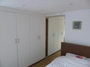 a bedroom with white cabinets and a bed at Studio Han Sur Lesse in Han-sur-Lesse +16 photos