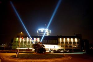 a building with lights on top of it at night at Devero Hotel BW Signature Collection in Cavenago di Brianza