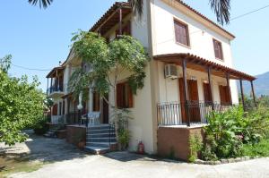 a house with a tree in front of it at Mr. Greek Villa in Petra +11 photos