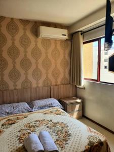 sypialnia z łóżkiem z dwoma ręcznikami w obiekcie Flat Wall Street w mieście Caxias do Sul