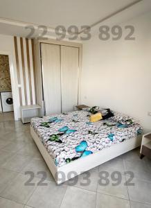 a bedroom with a bed with a price sign on it at S2 in second position beach Dar Allouche Kelibia in Hennchir Ksar Rhaleb