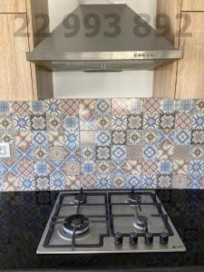 a stove top in a kitchen with a tile back splash at S2 in second position beach Dar Allouche Kelibia in Hennchir Ksar Rhaleb
