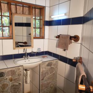 a bathroom with a sink and a mirror at Ng'ona Lodge in Maganga