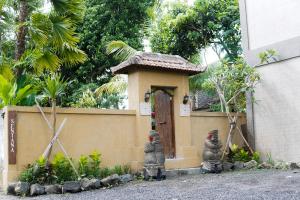 a small house with two statues in front of it at Sentana Villa Ubud in Ubud