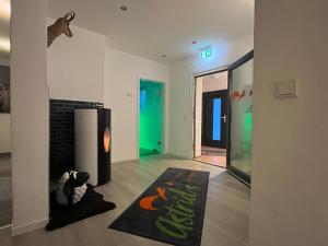 ein Wohnzimmer mit einem Kamin und einem Hund auf einem Teppich in der Unterkunft Astrid's Pension in Winterberg