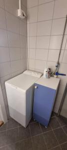 a small white refrigerator in a small room at Apartement in Drammen close to the main city in Drammen