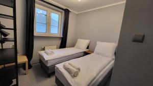 Posteľ alebo postele v izbe v ubytovaní Apartament Skarbka