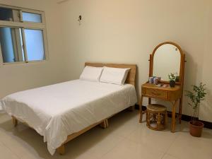 龍潭區的住宿－吾室，一间卧室配有一张床和一张带镜子的桌子