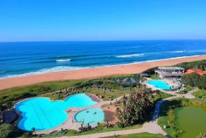 an aerial view of a resort and the beach at Stylish 19 Ocean's Edge 4 Bedroom Home, Zimbali in Ballito