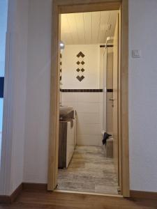a hallway leading to a bathroom with a sink at Pension Bergfried in Hallstatt