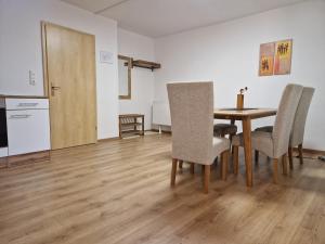 a dining room with a table and chairs and a kitchen at Pension Bergfried in Hallstatt