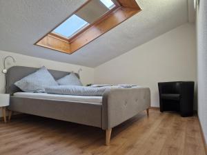 a bedroom with a bed with a skylight at Pension Bergfried in Hallstatt