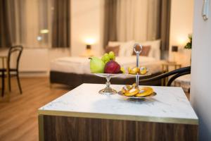 a bowl of fruit on a table in a hotel room at Pension Central I Self Check In in Vienna