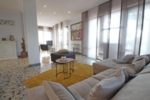 a living room with a couch and a table at Appartamento Dei Ronchi in Marina di Massa