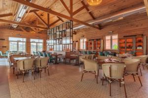 a restaurant with wooden ceilings and tables and chairs at Pestana Douro Riverside in Porto