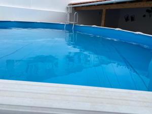 a large swimming pool with blue water at Casa Berlenga in Peniche
