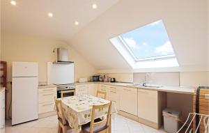 a kitchen with a table and a window at 2 Bedroom Amazing Apartment In Erpeldange-remich in Erpeldange-lez-Bous