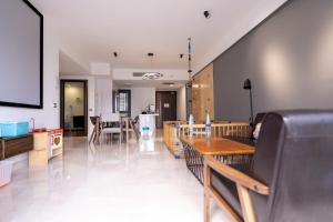 a living room with tables and a dining room at KL Top Location Kid's Theme White Collar Apartment in Kuala Lumpur