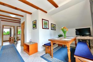 a living room with a table and a tv at Guest House Family Dukić in Rakovica