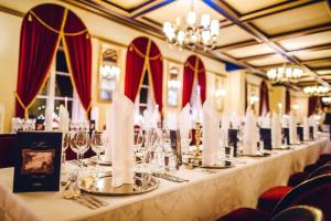 a long table with wine glasses and napkins at Hotel Haikko Manor & Spa in Porvoo